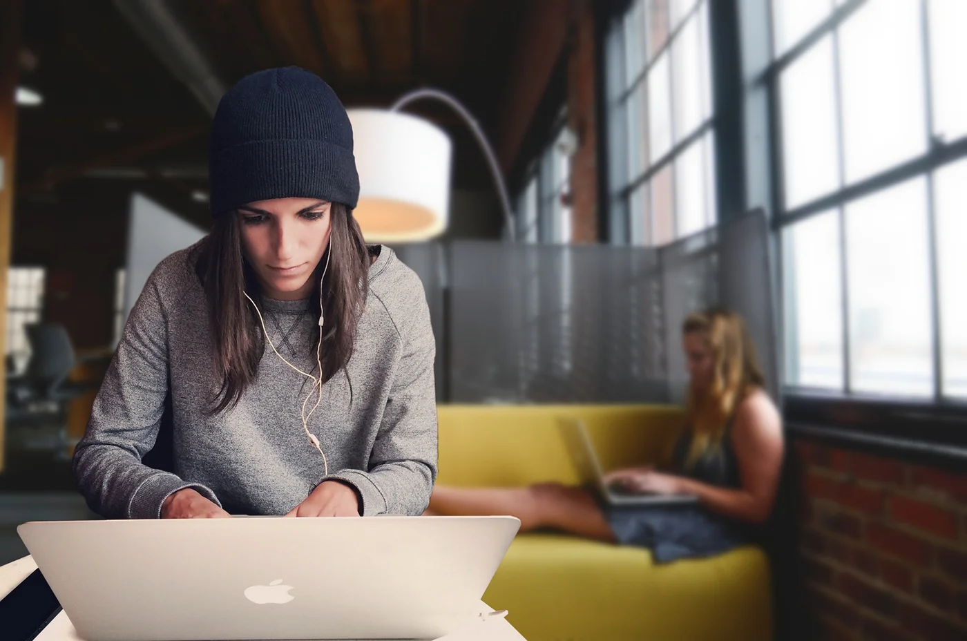 woman working at laptop in co-working place